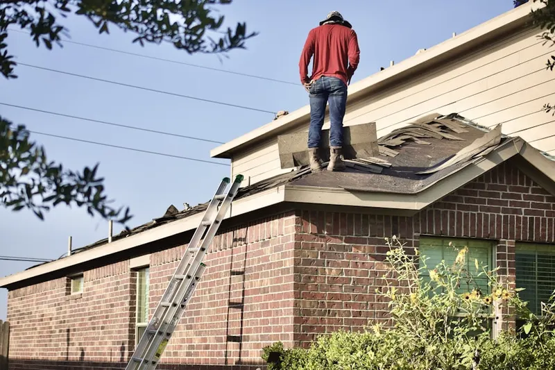 Professional roofer working on a residential roof in Trinity Lakes